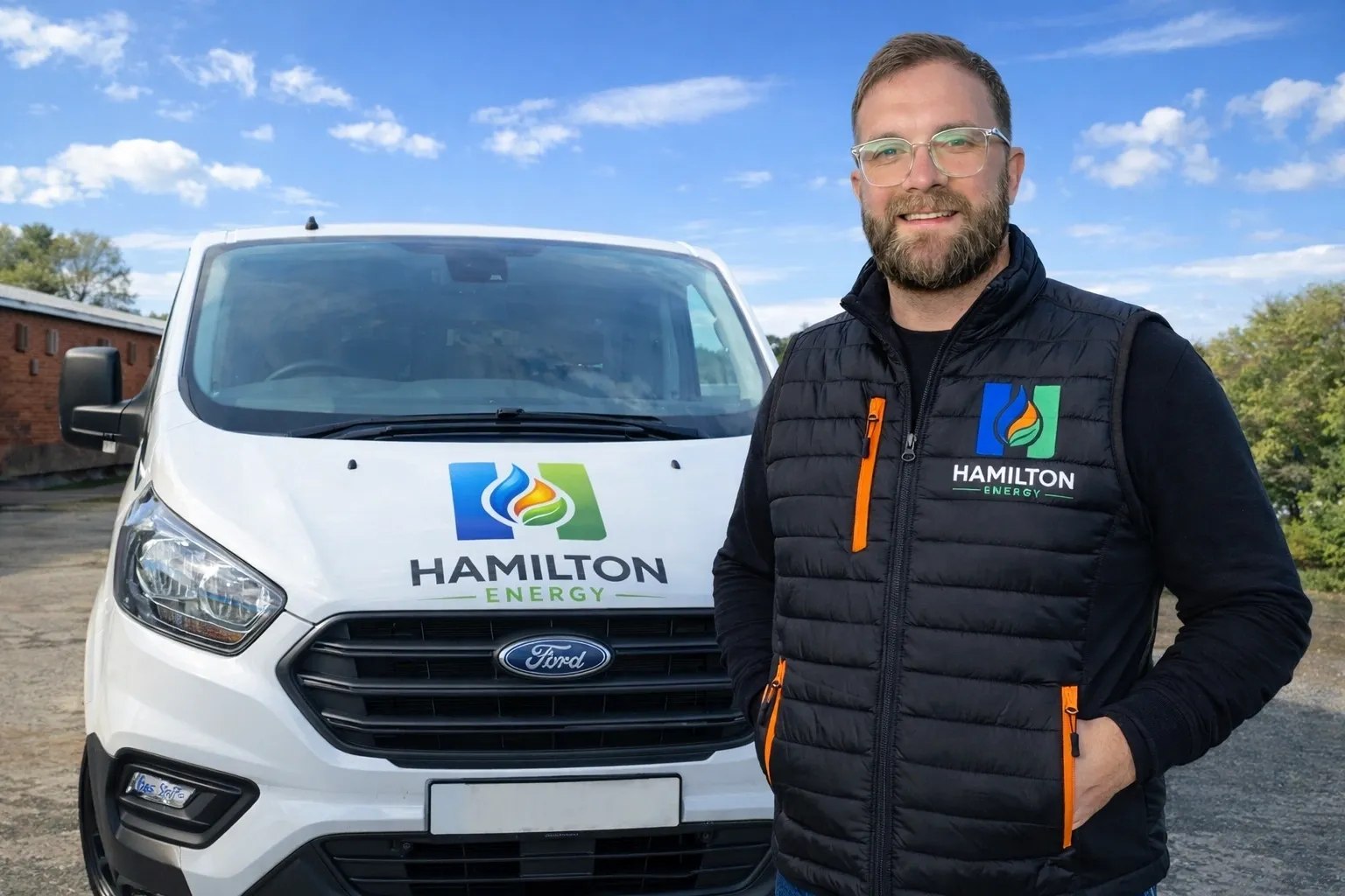 Scott from Hamilton Energy standing beside the branded company van